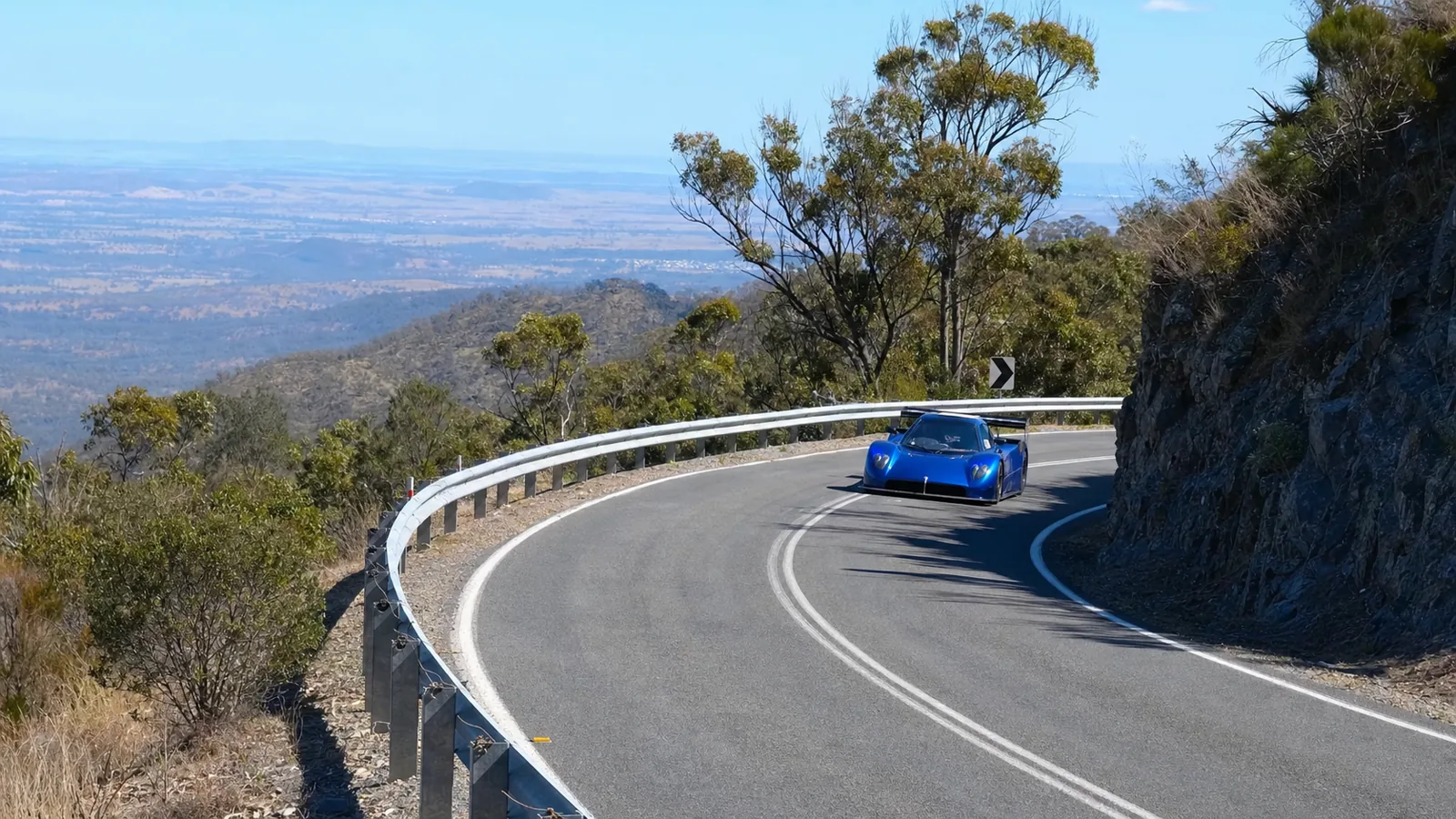 Competition car climbing a closed mountain road